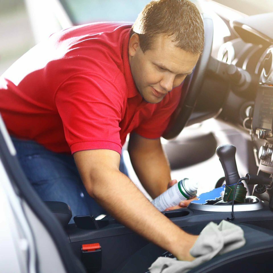 Man detailing interior of a car