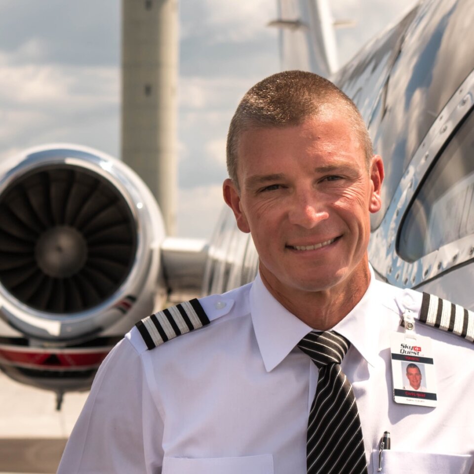 Pilot standing in front of a private jet